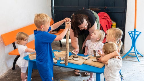 Children playing with wooden games at Llanerchaeron, Ceredigion